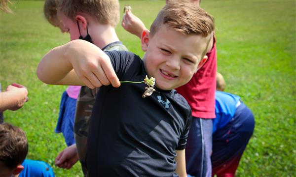 Boy holds up butterfly